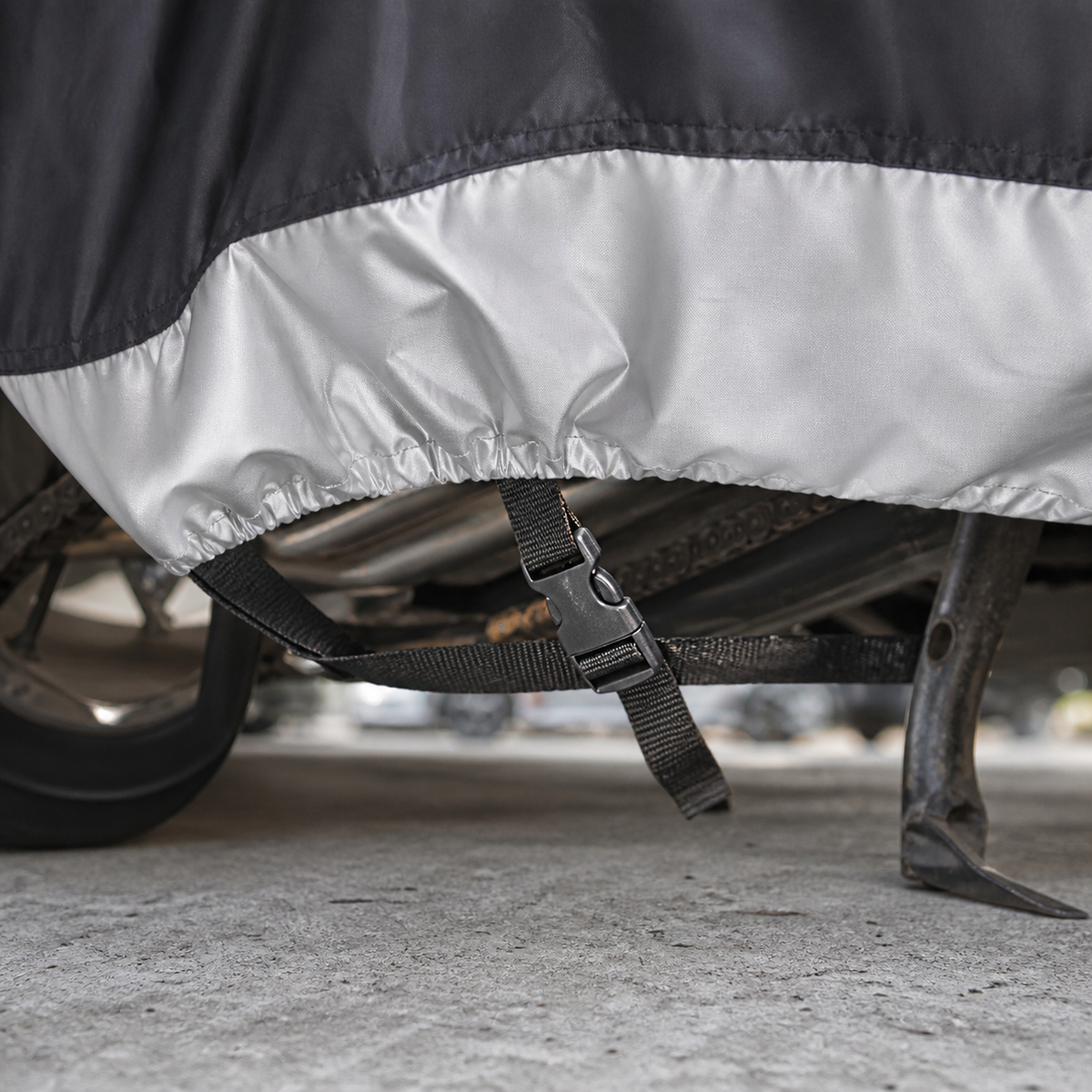 Windproof buckle and elastic hem detail under motorcycle cover